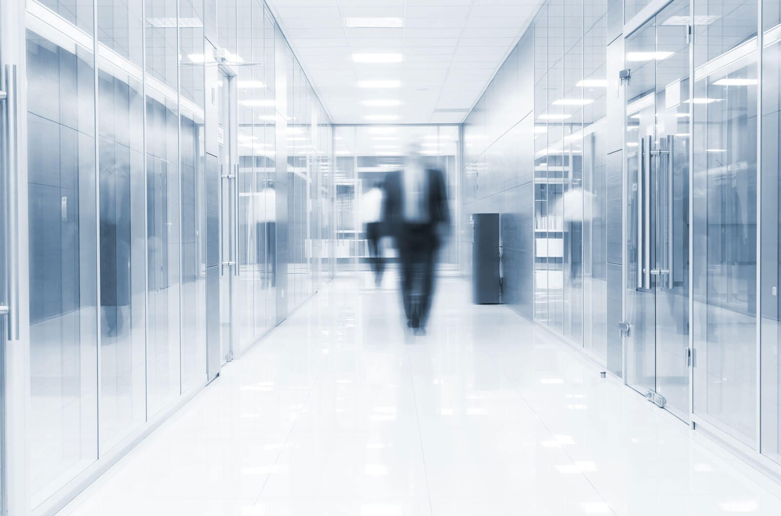 A man walking in an office corridor