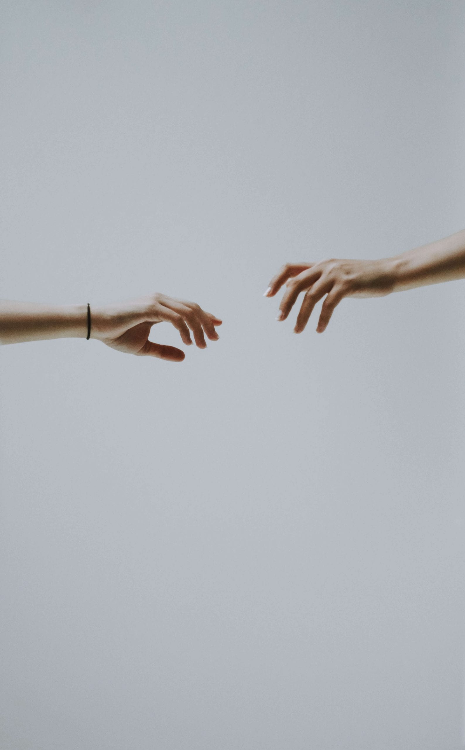 Hands reaching for each other