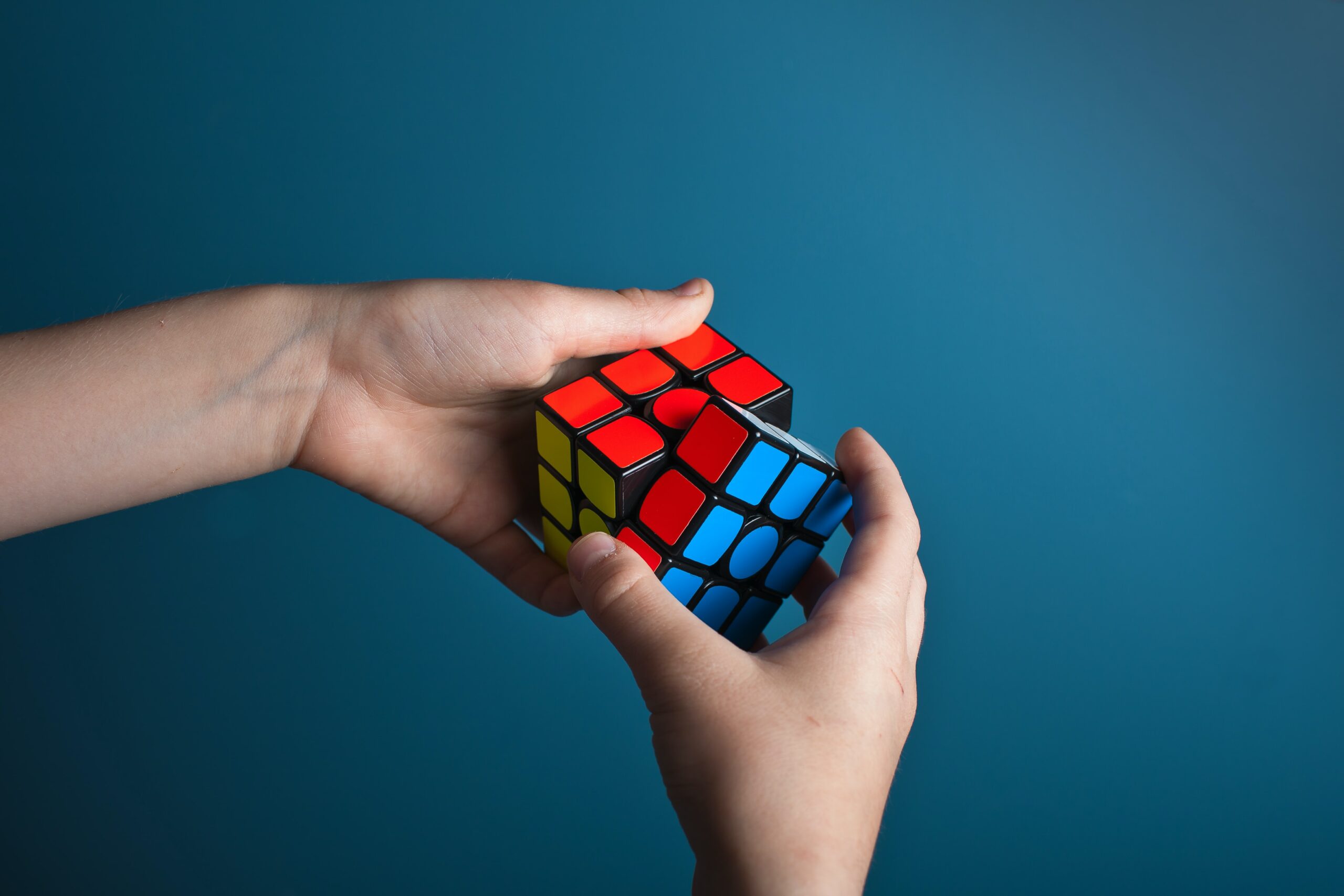 hands maneuvering a Rubik's cube